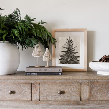 Vintage Pine framed print on a wood console with greenery